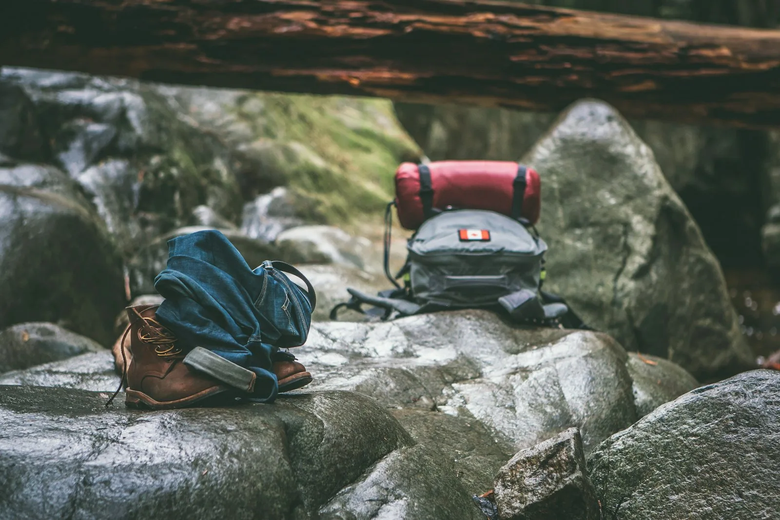 Two gray and orange backpacks on gray rocks